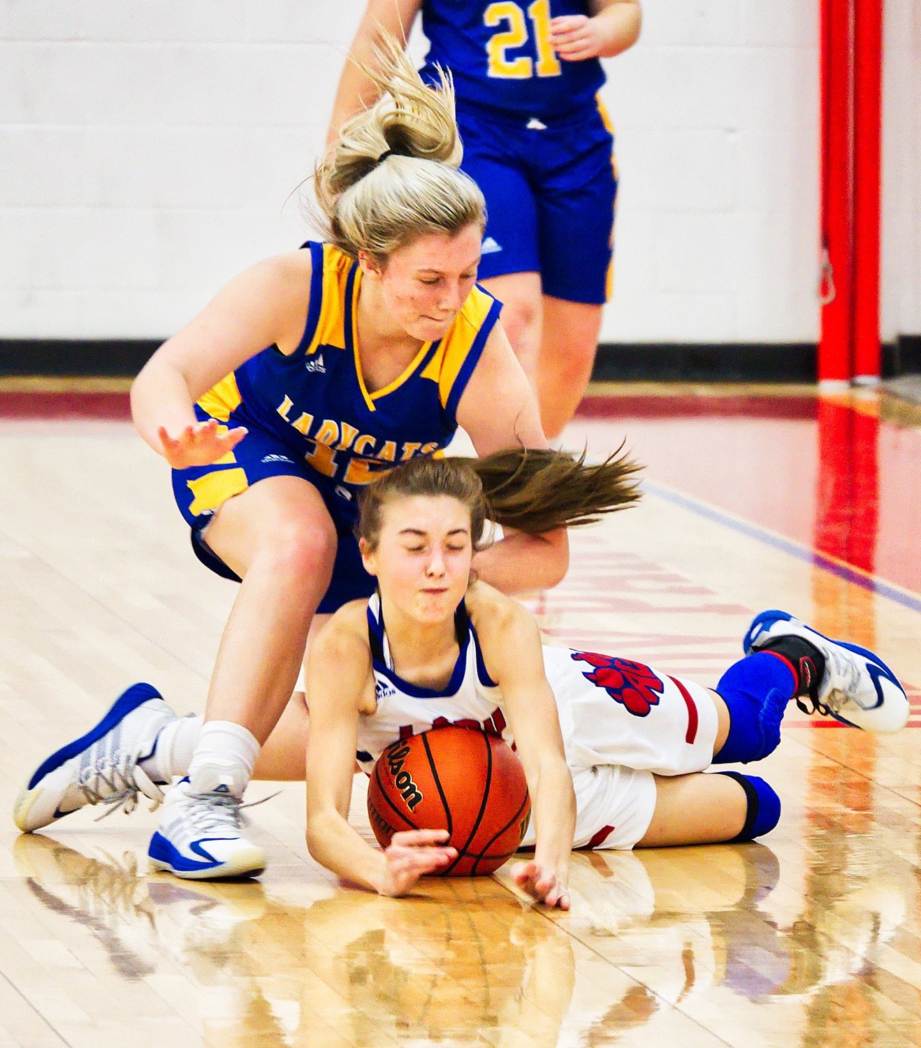 Karmin Wright (bottom, right) fights for a loose ball on the hardwood. [see more shots + purchase prints]